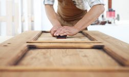 carpenter work the wood with the sandpaper